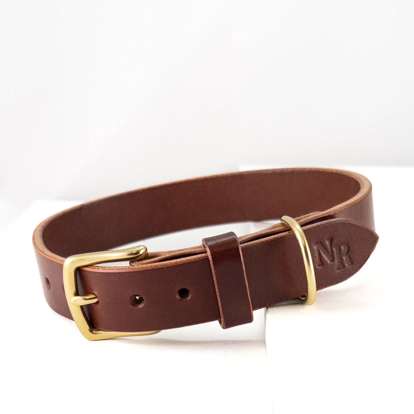 Custom leather dog collar in Walnut, handcrafted with solid brass hardware.