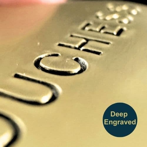 Close-up of engraving on brass pet ID tag.